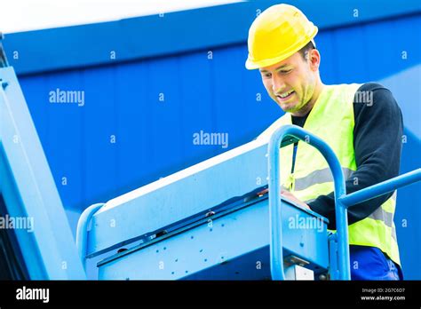 Construction workers or crane driver on site driving hydraulic lifting