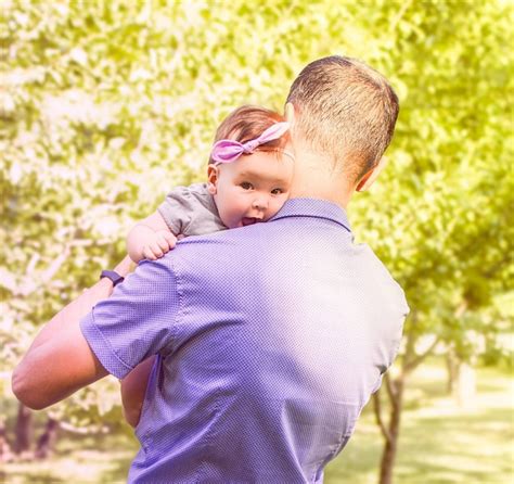 Premium Photo Dad Holds His Little Daughter In His Arms While Walking