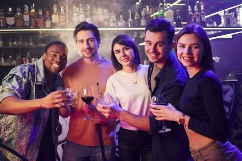premium photo standing together group of friends having fun in the night club