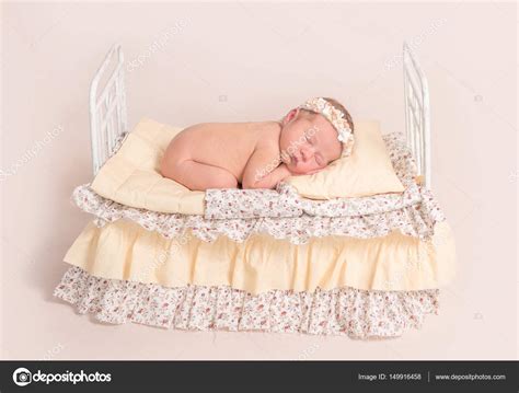 Infant Sleeping On Bed With Yellow Sheets — Stock Photo © Tan4ikk