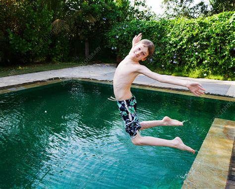 Boy Jumping Into Swimming Pool Stock Image F Science Photo Library