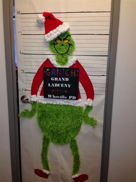 The Grinch Is Holding A Sign On His Door