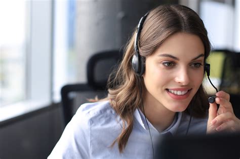 Beautiful Smiling Call Center Worker In Headphones Is Working At Modern