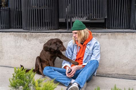 Friendly Homeless Dog Sitting With Guy In Downtown Begging Food Giving