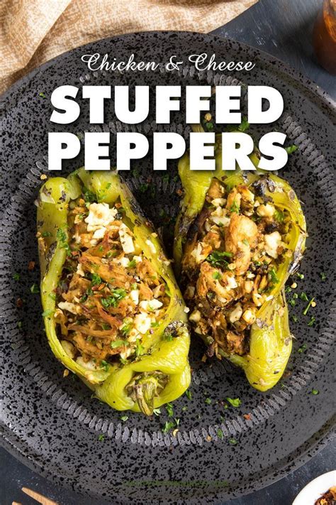 Stuffed Peppers With Chicken And Cheese On A Black Plate