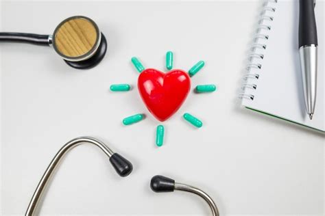 Premium Photo Red Heart With Pills And A Stethoscope On A White