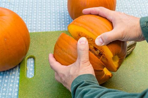 Cutting Open A Pumpkin In The Kitchen Stock Image Image Of Vegetables