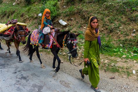These people who live a nomadic lifestyle because they have to also have children. Nomadic people on horseback near the mountain town of ...