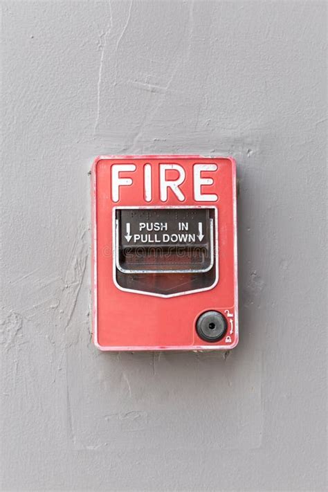 Red Fire Alarm Switch On Exterior Cement Wall Of Commercial Building