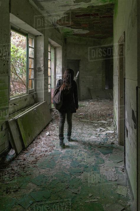 Girl Walk In Old Abandoned Building In Decay Hallway To Explore It From