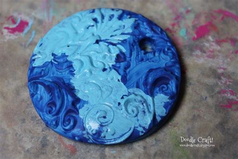 A Blue And White Painted Button Sitting On Top Of A Table