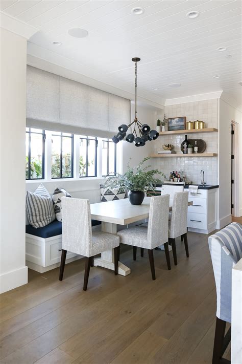 A Dining Room Table And Chairs With White Walls