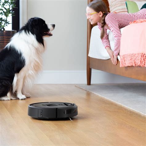 The bin release tab has a bin icon on it. หุ่นยนต์ดูดฝุ่น iRobot Roomba i7+ - สั่งซื้อออนไลน์ราคาพิเศษ