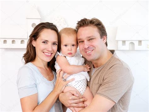 Happy Mother And Father Holding Cute Baby At Home — Stock Photo
