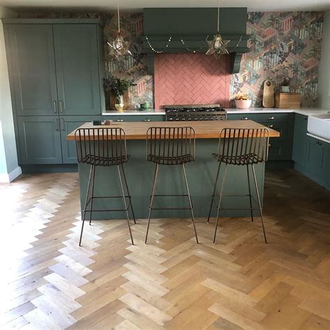 Stained glass and iron fixture hangs over the centre island to shine a soft light over the canadian peribonka granite top. Farrow-and-Ball-Smoke-Green-kitchen-pink-accents-with ...