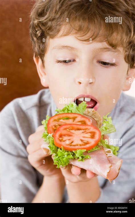 Boy Eating Sandwich Stock Photo Alamy