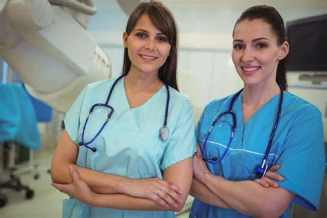 Portrait Of Two Female Nurse Standing With Arms Crossed Stock Image Image Of Medical