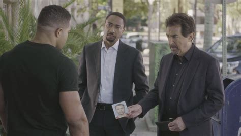 Agent Walker and David Rossi speak to a witness. Criminal Minds Season