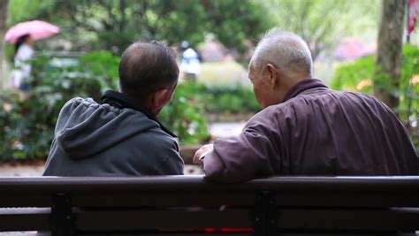 Shanghainov 07 2015 Two Asian Senior Men Talking While Sitting On