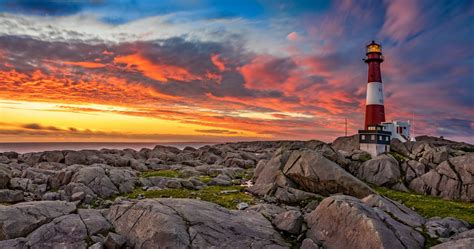 Download 2050x1080 Lighthouse Sunset Rocks Clouds