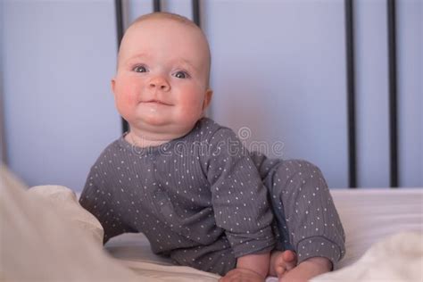 Cute Happy 6 Month Baby Girl In Diaper Lying And Playing Stock Photo