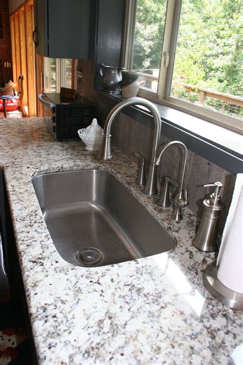 The grey island is painted a darker color than the main wall color. ashen white granite slab gray cabinet - Google Search | White granite countertops, Engineered ...