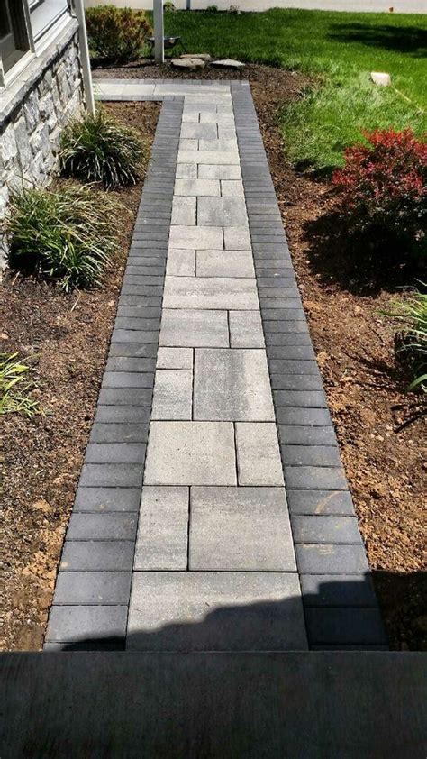 We finished the walkway simply by digging up the grass, adding red lava rocks, flowers, and solar lights to boost up our curb appeal! Techo-Bloc Paver Walkway in Progress... | Pathway ...