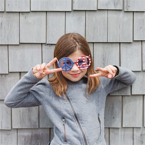 8 year old wearing patriotic peace sign glasses square format by stocksy contributor amanda