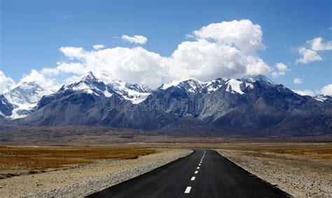 Highway By The Snow Mountain In High Altitude Region Stock Photo