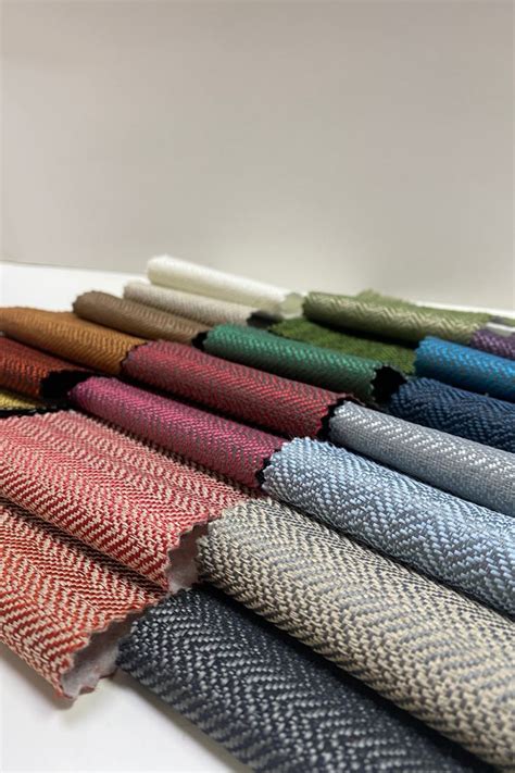 Several Colors Of Fabric Laid Out In Rows On A White Surface With One