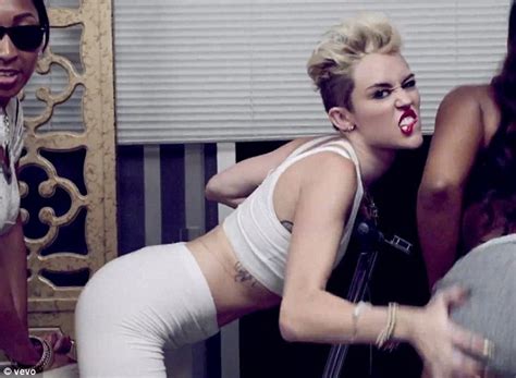 miley cyrus writhes around on bed in white spandex for new single we can t stop her raunchiest