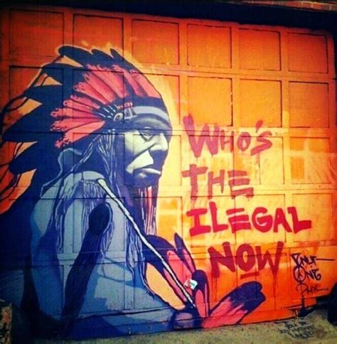 Graffiti On The Side Of A Garage Door That Says Whos The Illegal Now