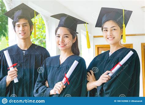 People With Black Graduation Gowns Hold Diploma Stock Photo Image Of