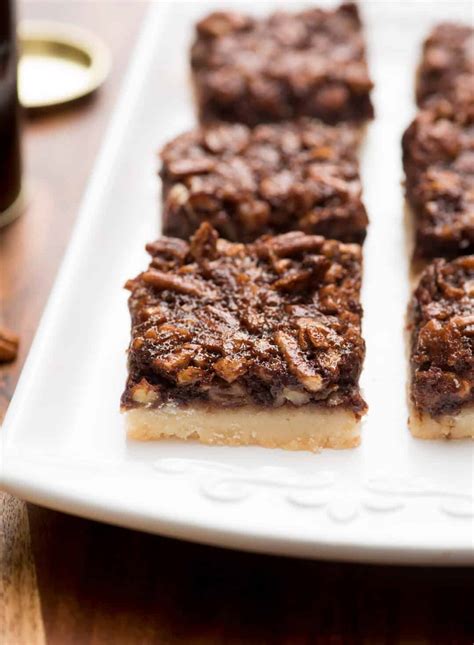 If you've never made pecan pie bars, imagine those gooey filling and toasty pecans of pie fame filling a simple crust and baked in a big pan instead of a pie plate. Chocolate Bourbon Pecan Pie Bars | Valerie's Kitchen
