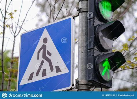 Traffic Lights Green Color And Pedestrian Crossing Sign In A City