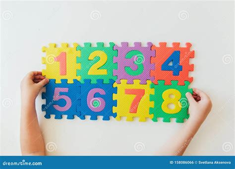 Child`s Hands Playing With Numbers Learning Simple Multiplication