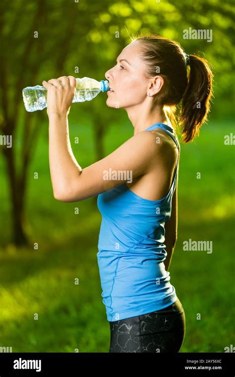 Young Woman Drinking Water After Fitness Exercise Stock Photo Alamy