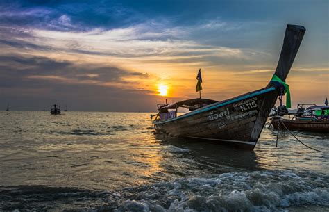 Photo Of Brown Boat At Sea During Golden Hour · Free Stock Photo