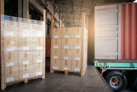 Stacked Of Cardboard Boxes Wrapped Plastic On Pallet Waiting To Load Into Shipping Container