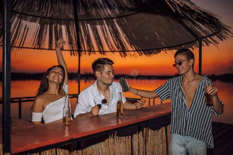 Smiling Friends Partying On The Beach Bar With Drinks During Sunset Stock Image Image Of Group