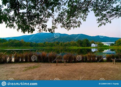 Wood Bench With Beautiful Lake At Chiang Mai With Forested Mountain And