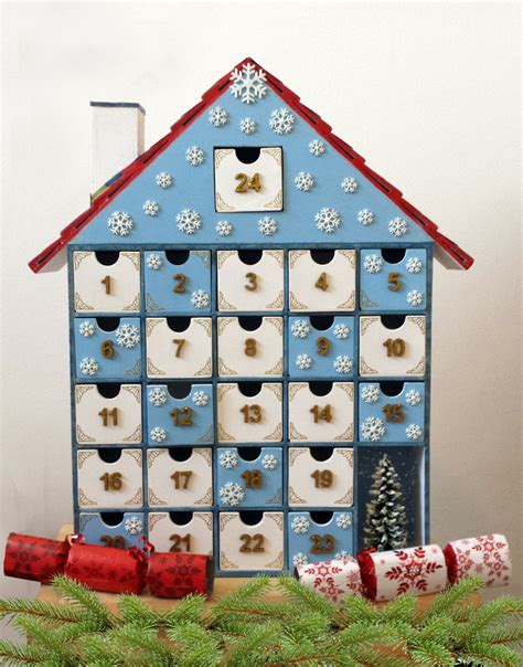A Blue House Shaped Like A Calendar With Christmas Decorations Around
