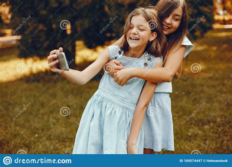 Two Cute Girls Have Fun In A Summer Park Stock Image Image Of