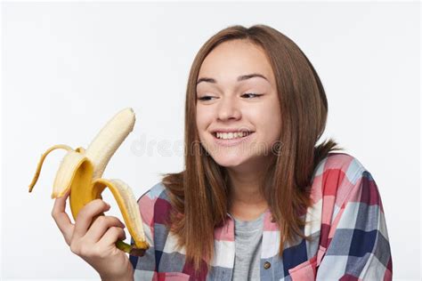 Portrait Of A Teen Girl Holding Half Peeled Banana Stock Photo Image