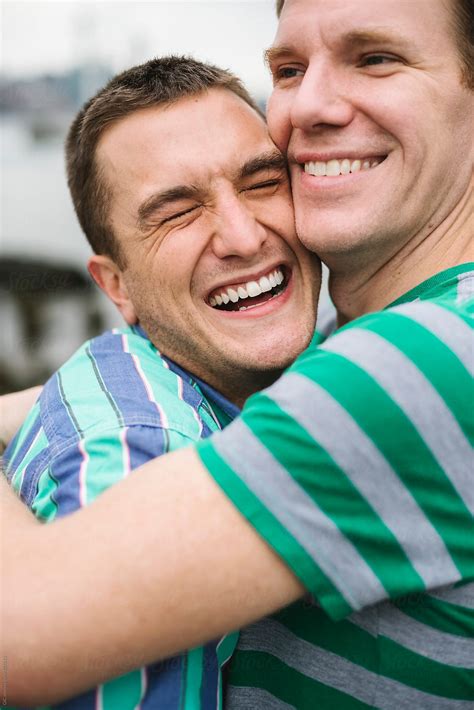 Happy Gay Couple Hugging Outdoors By Simone Wave