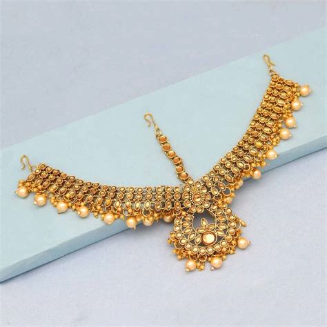 This heavy gold maang tikka with chains and green drops. Gold maang-tikka - Jaipur Mart - 3096412