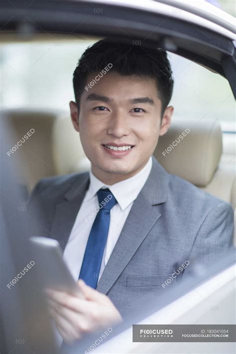Chinese Businessman Sitting On Car Back Seat — Formal Wear Convenience
