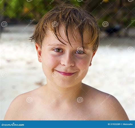 Happy Boy With Wet Hair At The Beach Smiles And Looks Very Self Stock
