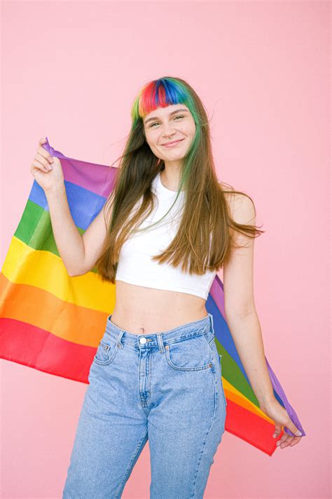 The classic pride flag was a rainbow and was designed by gilbert baker in 1977. Smiling Woman Holding a Gay Pride Flag · Free Stock Photo