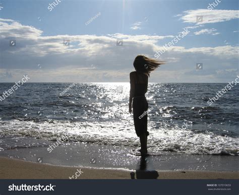 Silhouette Girl Standing On Sea Shore Stock Photo 107010659 Shutterstock